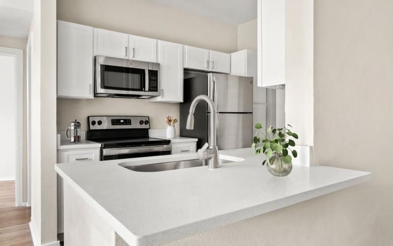a kitchen with white cabinets
