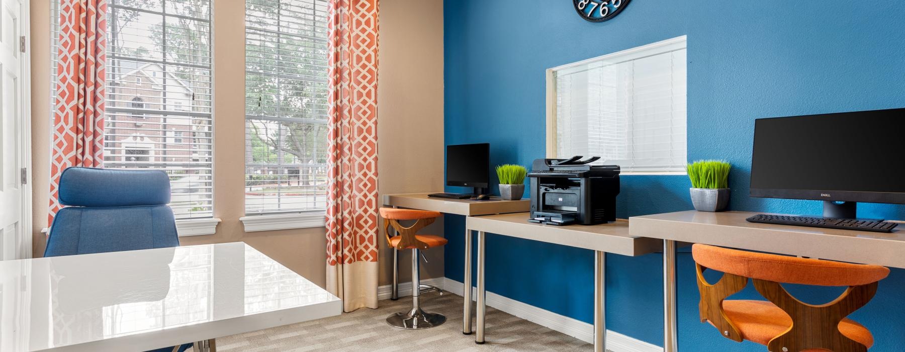 a room with a desk and chairs