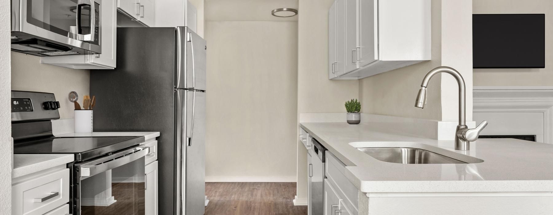 a kitchen with white cabinets
